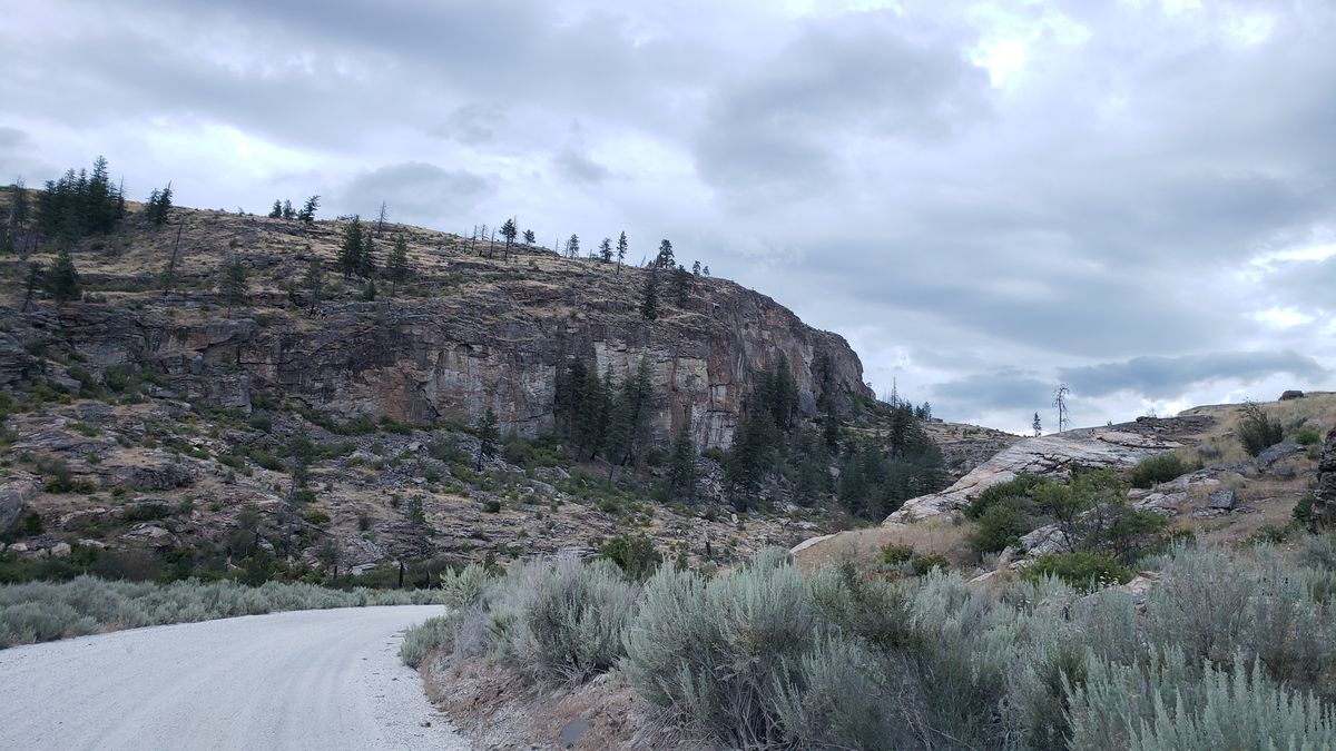 McLaughlin Canyon walls in summer morning light showing the scale of gneiss cliffs where fracture caves form